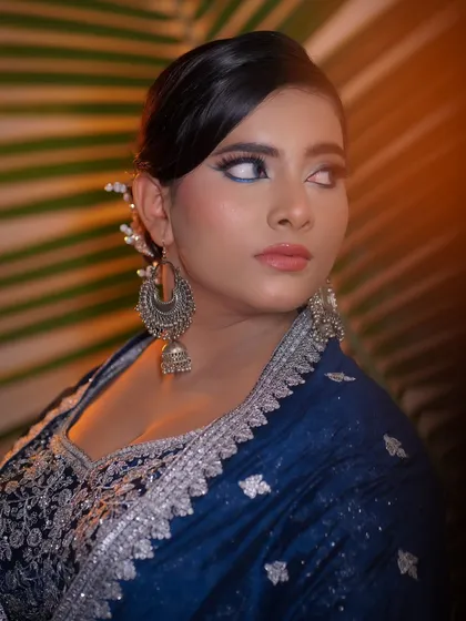 A side profile that captures the elegance of the look, paired with large silver jhumkas.