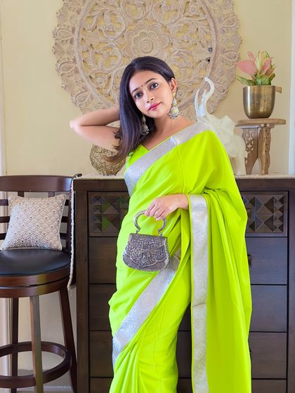 A full shot of the neon saree look. I kept the accessories simple with silver jhumkas and a metallic bag to let the color be the hero.