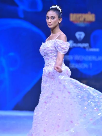 A side profile of this sparkling A-line gown, highlighting the intricate sequin work and the graceful movement of the tulle.