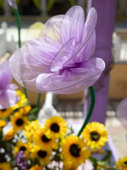 A macro shot of the delicate, handcrafted purple flowers used in the decor, highlighting our focus on quality and craftsmanship.