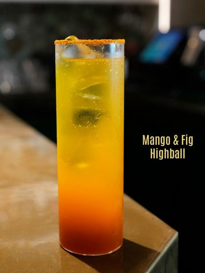 The Mango & Fig Highball, a celebration of fruit. This tall, refreshing drink balances the sweetness of mango with the earthy notes of fig.