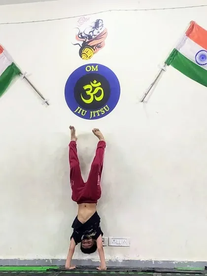 A demonstration of incredible strength and balance with a handstand. Yoga and calisthenics are part of our program to build complete body control.