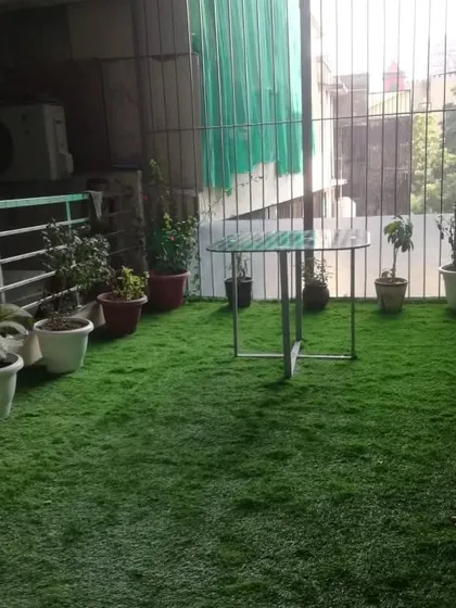 The owner's potted plants look even better now against the backdrop of their new green balcony floor.