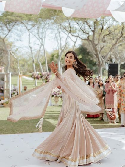 A full-length twirl shot, showing the beautiful movement of the lehenga.