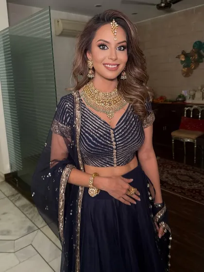 Anushka's smile says it all. Her bold eye makeup is perfectly balanced with a soft lip color for a stunning evening look.