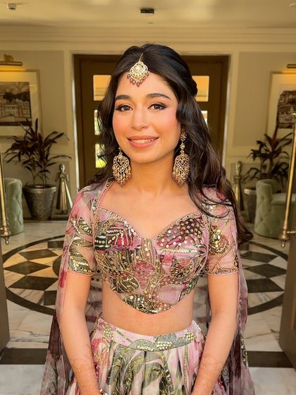 A close-up of the bride, her soft waves and half-up style beautifully framing her face.