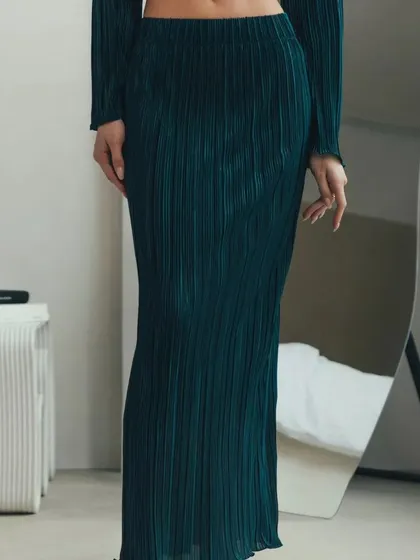 A view of the pleated maxi skirt from the two-piece set, showing its full length and the beautiful texture of the fabric.