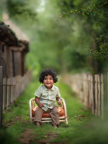 This little boy with the most amazing curls, sitting in a rustic chair in a country lane setting. This was a special session, recreating photos I took for his uncle years ago.