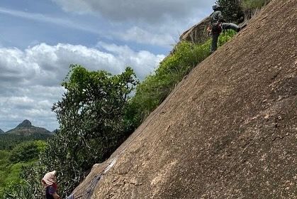 A climber on a new multi pitch route at Gethnaa, with a belayer below. This area is perfect for those looking to get into longer, more adventurous climbs.