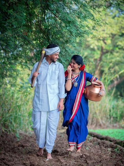 A candid walking shot from the Shetkari series. The couple shares a laugh while walking through the field, creating a memory that is both beautiful and genuine.