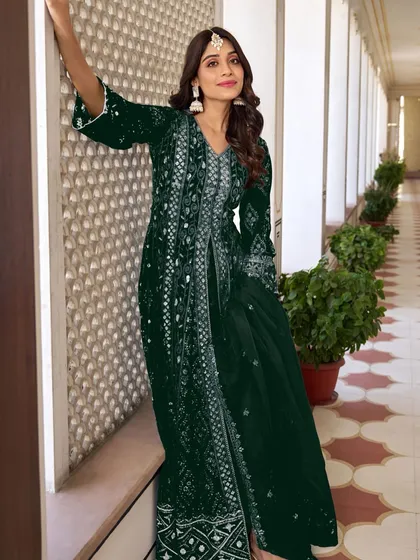 This bottle green Anarkali is a vision of elegance. The heavy embroidery work makes it a statement piece, perfect for making a lasting impression.