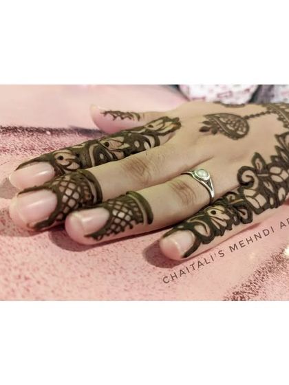 Another angle of the elegant floral vine design, showing how it gracefully covers the side of the hand and fingers.