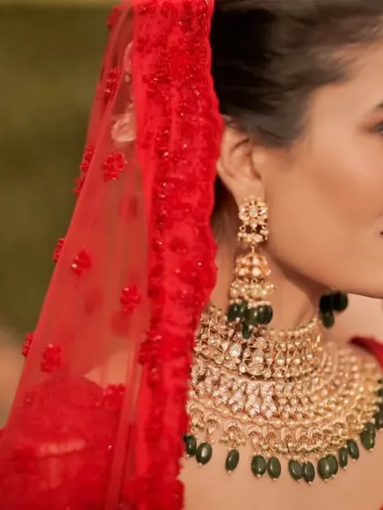 A close up on the bride's profile, showcasing her intricate jewelry and flawless makeup. We pay close attention to the details that complete the bridal look.