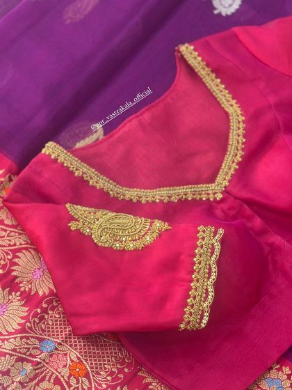 The V-neckline of the pink paisley blouse.