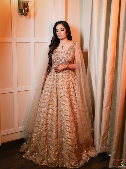 Ashima, looking like a dream in her shimmering gown. The makeup is soft and romantic, with a touch of sparkle.