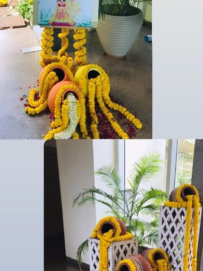 Creative use of marigold garlands spilling out of clay pots, a beautiful decor element for an entrance or corner.