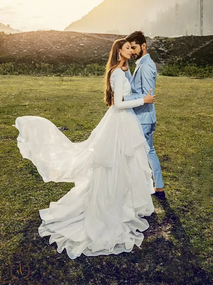 A stunning shot of a bride's dress flowing in the wind in a Kashmiri meadow. This image is the epitome of a fairytale pre-wedding moment, combining elegance and natural beauty.