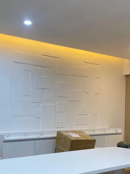 The custom 3D wall panel for the Vishu Home dining area during installation. This shows the raw MDF and framework before the final finishing, revealing the complexity behind the seamless result.