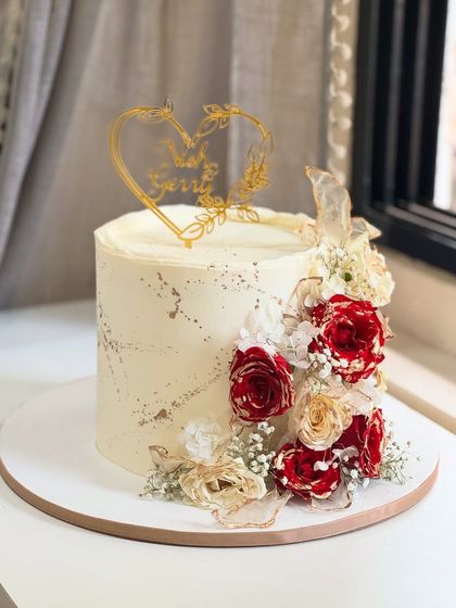 When love blooms, it looks like this. A dreamy blend of elegance and romance, this cake is adorned with fresh red and white roses and delicate textures, perfect for a heartfelt celebration.
