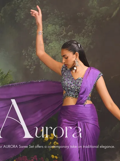 Sculpt your style with the Aurora Saree Set. This ensemble offers a contemporary take on traditional elegance with a futuristic drape and an intricately embellished blouse in a striking purple hue.