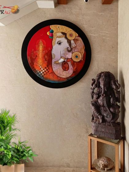A circular Ganesha painting by Sachin Kharat is perfectly placed next to a Ganesha sculpture, creating a dedicated corner of spiritual art and tranquility.