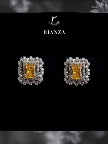 These are our popular changeable color stone earrings, shown here with a vibrant yellow sapphire. The central stone can be swapped to match different outfits, making them a valuable trousseau piece.