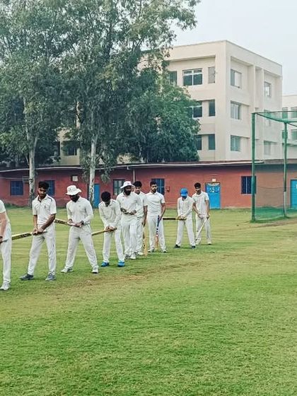 A coach observes the players during a group drill, ready to provide corrections. Attention to detail is paramount.