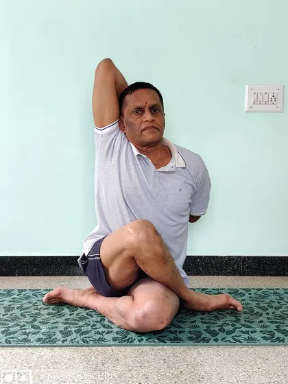 Gomukhasana, or Cow Face Pose. This seated posture is excellent for opening the shoulders and hips. A strong and open body is necessary for sustained and effective pranayama practice.