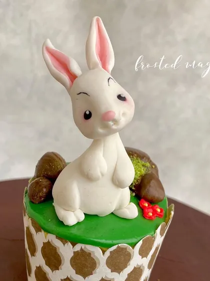 The expressive face of the rabbit topper, crafted entirely from fondant.