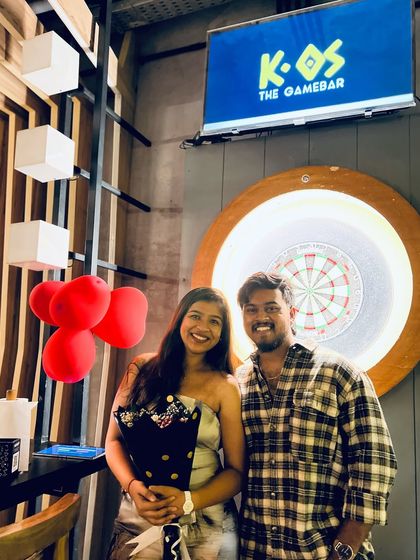 Another happy couple posing by our dartboard, making memories during the month of love.