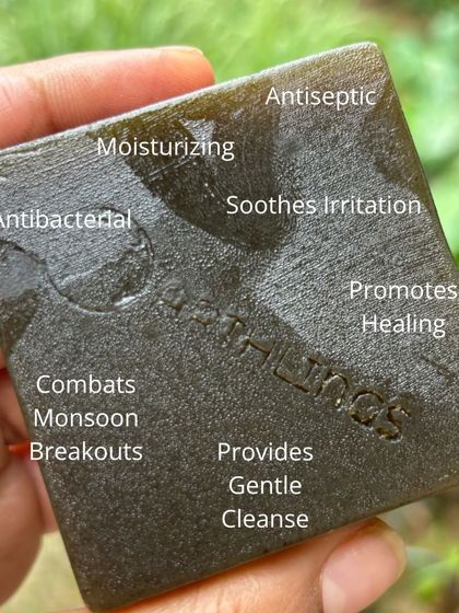 The many benefits of our Herb Bath Soap displayed on the bar itself. It's antibacterial, moisturizing, antiseptic, and soothes irritation, making it a monsoon essential.