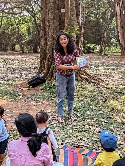 Here I am, in my element, narrating a story with animated expressions. I believe in performing the story, not just reading it, to truly capture the children's imagination during our interactive reading events.
