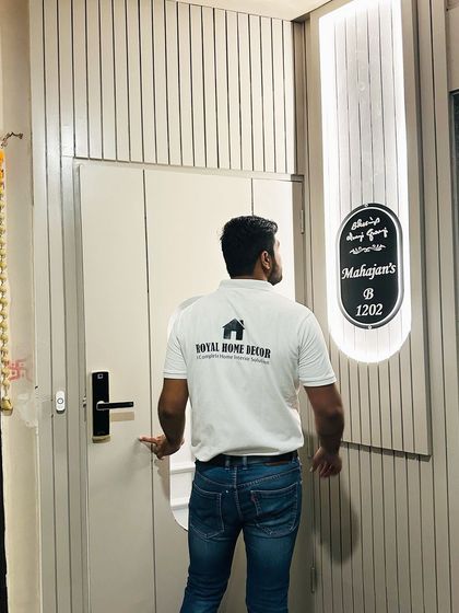 A full view of the completed main door at JM Florence, showcasing the clean, modern design and the personalized backlit nameplate.