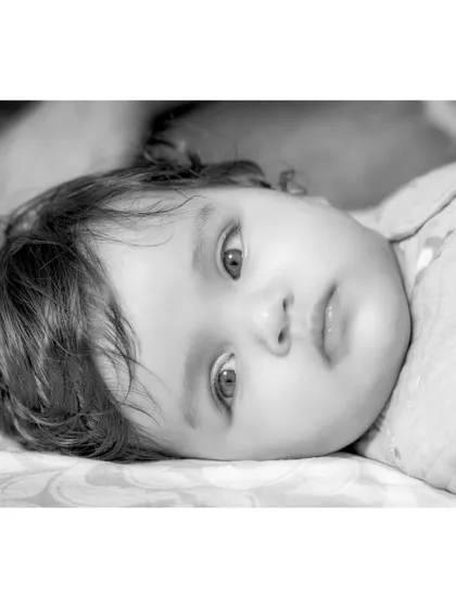A peaceful, reclining portrait of baby Anika. The black and white treatment adds a soft, artistic quality to this quiet moment.