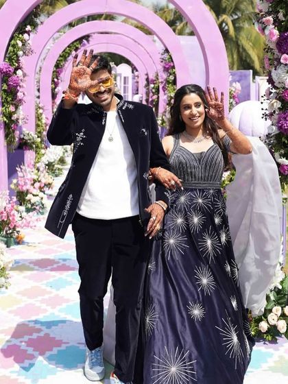 The happy couple making their way through the pastel-themed carnival walkway, ready for a day of fun and games.