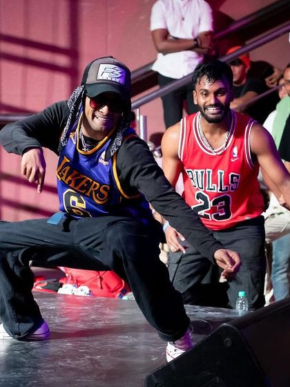 A fun moment during a battle, with dancers sharing a laugh and good vibes on stage.