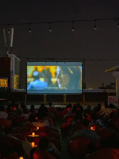 The screen is lit, the audience is settled, and the movie is about to begin. A typical night at our 1 MG Lido Mall rooftop cinema in Bangalore.