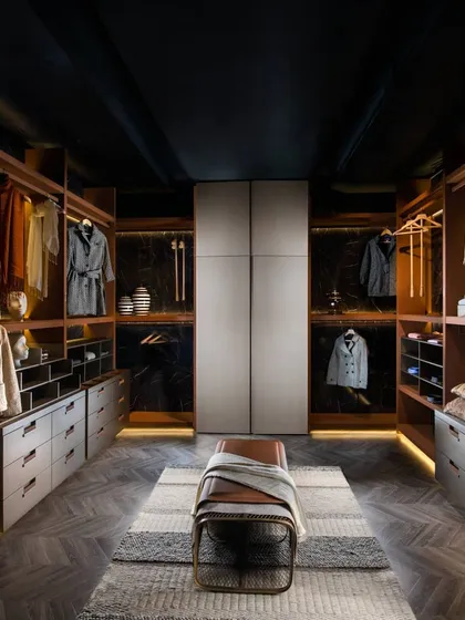 We believe a wardrobe should be a luxurious dressing space. This walk-in closet is designed with clean lines and warm, ambient lighting, featuring a mix of open shelving and drawer units to create a perfect, organized solution for your entire collection.