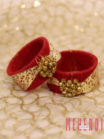 These red and gold bangle-style napkin holders also make for a unique and reusable wedding favour. They add a touch of festive elegance to any table setting.