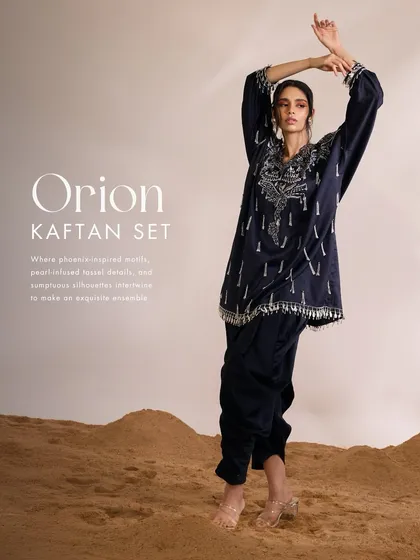 The Orion Kaftan Set in navy, where phoenix-inspired motifs and pearl-infused tassels create a sumptuous and exquisite ensemble.