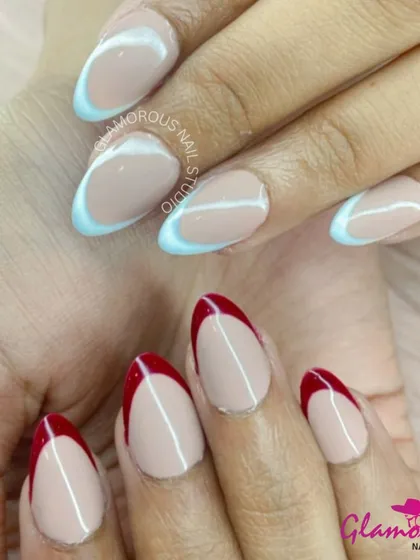 Can't decide on a color? Have both! This unique look features a mismatched French manicure, with deep red tips on one hand and cool baby blue tips on the other, for a bold and playful statement.