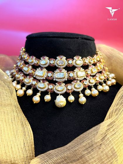 True beauty lies in the details. This three tier Kundan choker merges centuries old craftsmanship with a fresh silhouette, while the delicate pearl drops add a final touch of enchantment and grace.
