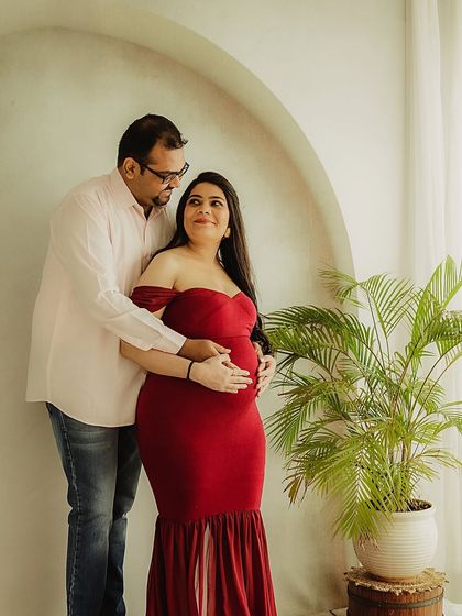 A quiet moment of connection by the window. The natural light and simple setting create a serene and intimate atmosphere for this couple's portrait.