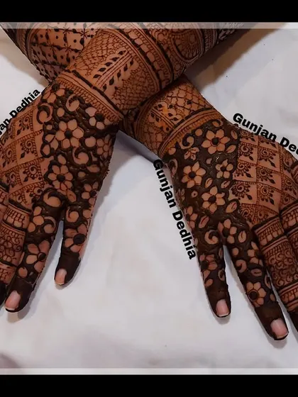 The back-hand design for an engagement, featuring dense floral and geometric patterns that cover the hands completely.