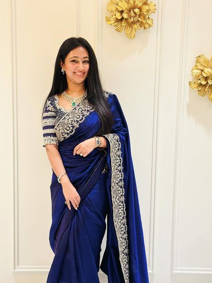 Another shot of the guest in her stunning blue saree, showcasing the beautiful drape and the intricate silver work on the blouse.
