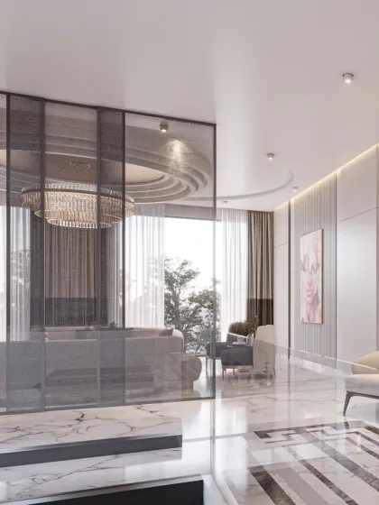A glass partition provides a subtle separation between living zones while maintaining an open feel. The reflection of the chandelier adds another layer of visual interest.