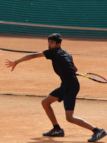 A player hitting a forehand with great extension and follow-through. This is a great example of the modern forehand technique we teach.