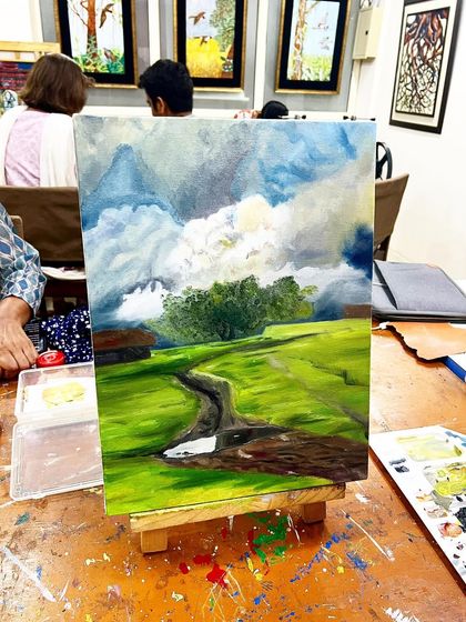 A beautiful landscape painting on an easel in our studio, created by one of our adult students during a class.