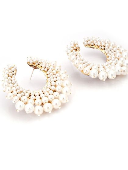 Our new pearl hoops are a modern classic. The crescent shape is filled with graduating pearls for a bold yet elegant look.