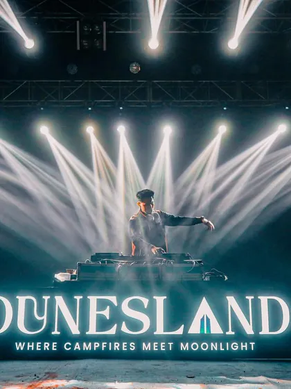 On stage at the Dunesland festival, where I delivered a headline performance. This image showcases the professional, large-scale stage presence I bring, complete with custom branding and a massive light show.